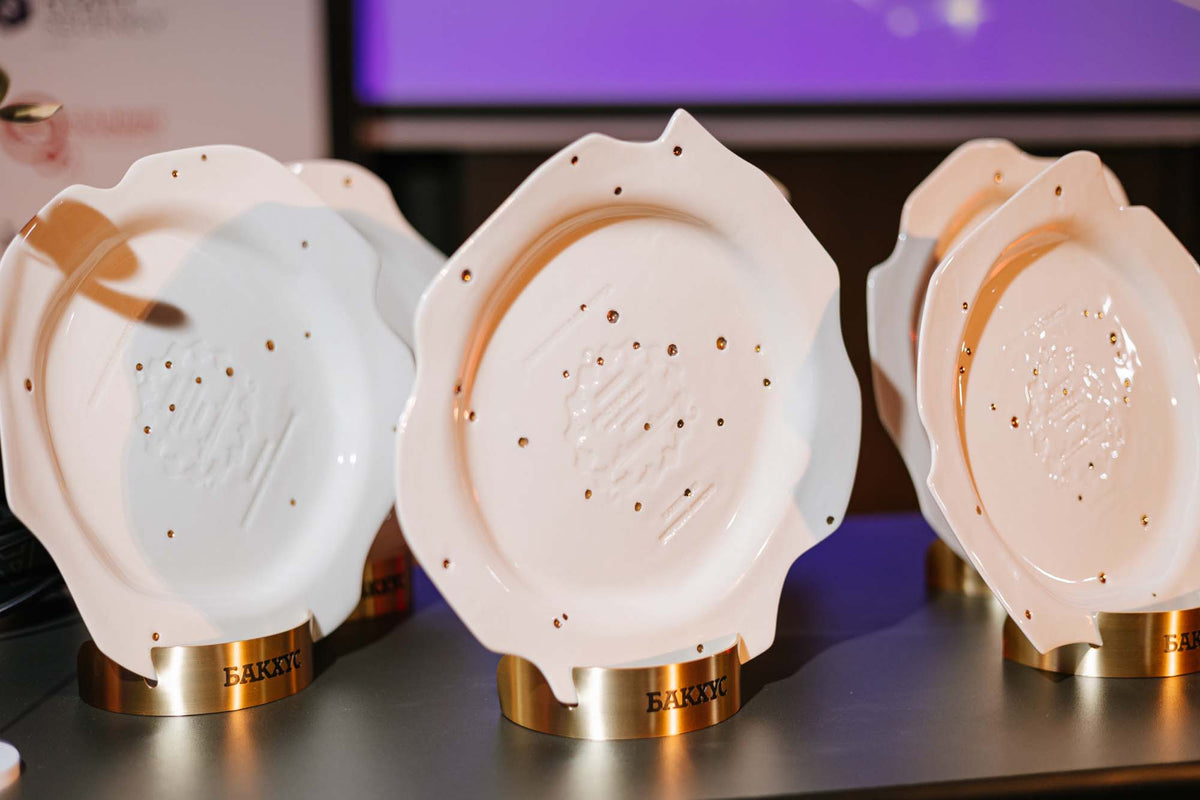 Handmade porcelain award plates on brass stands, made for the Bacchus Restaurant of the Year awards