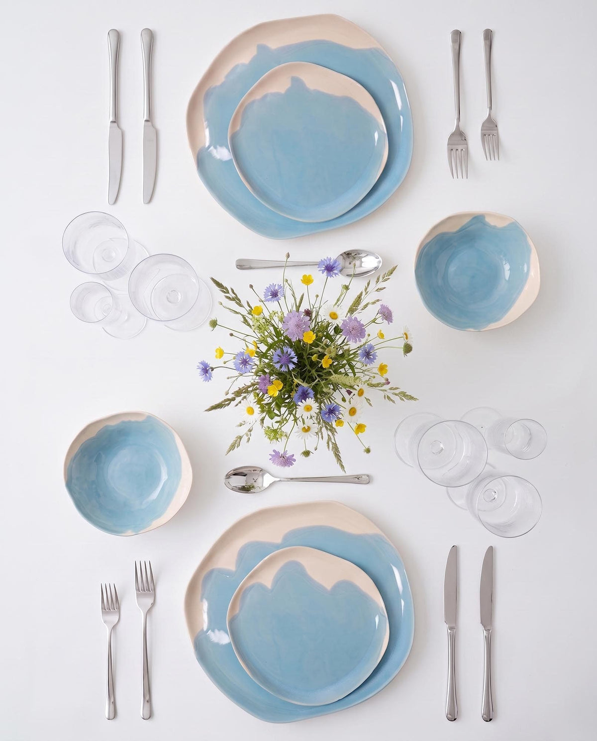 Table setting with Sky Blue handmade porcelain plates and bowls, featured in La Casa in Ordine