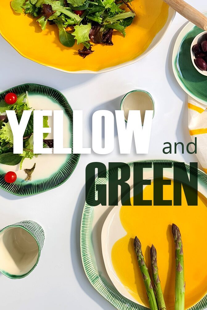 Yellow and green handmade porcelain plates with salad and asparagus for a summer table