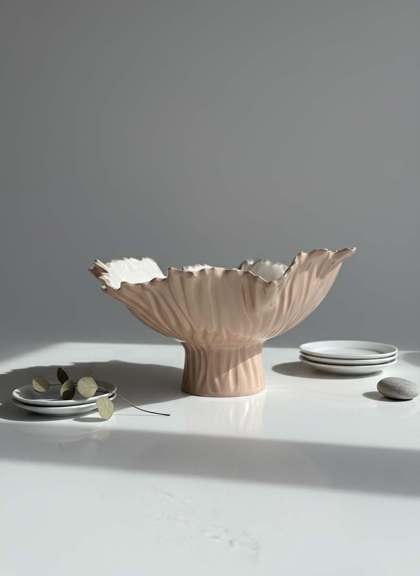 Mocha-glazed pedestal serving bowl with matching ceramic plates and cups