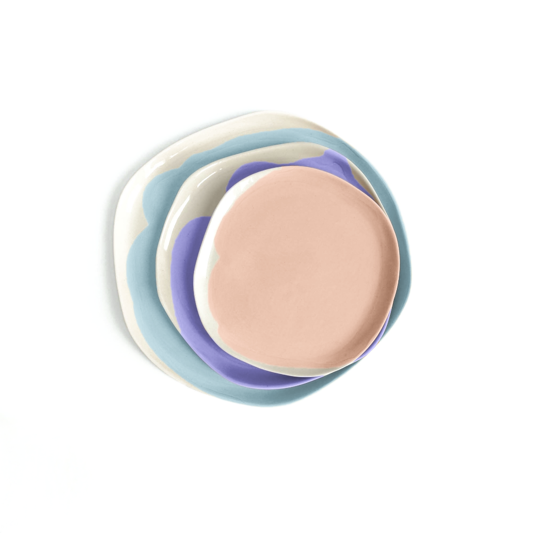 Stacked handmade plates in pale blue, green, lavender and pink
