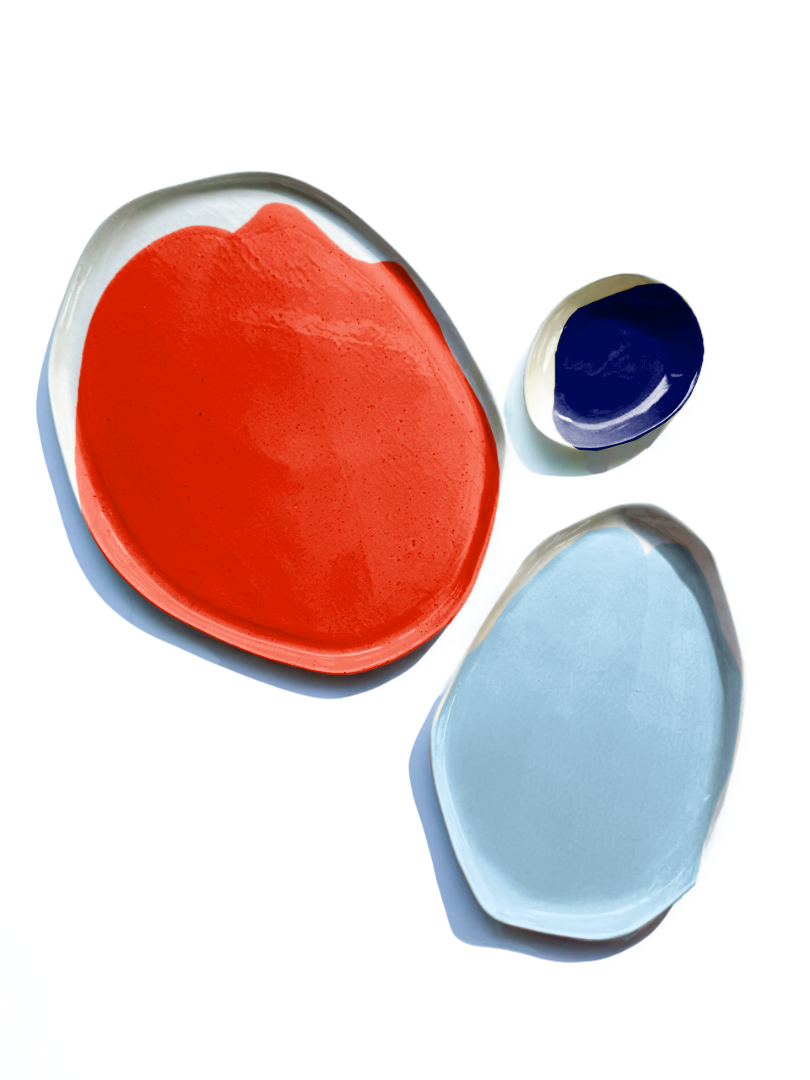Red and blue serving trays with a small blue ceramic dip bowl