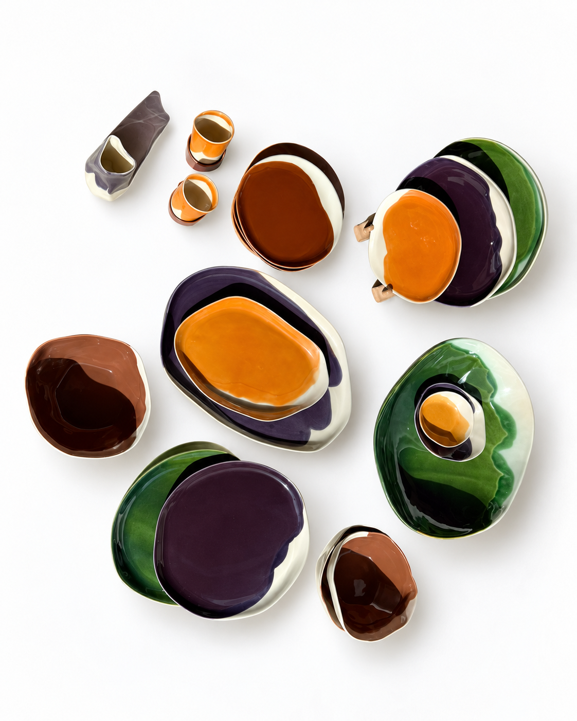 Overhead arrangement of autumn-glazed plates, serving platters and bowls