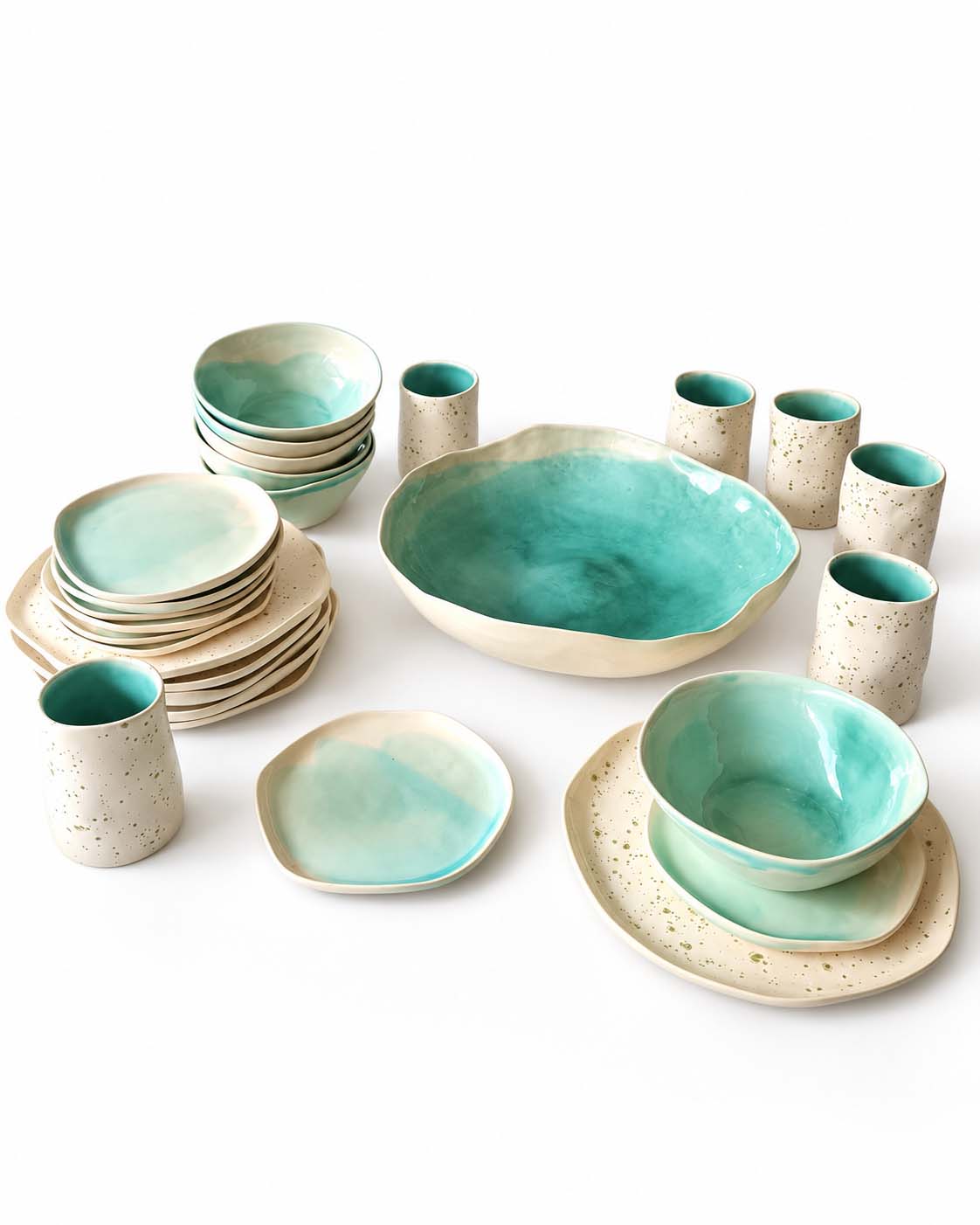 Handmade dining set with green plates, bowls, cups and a large serving bowl