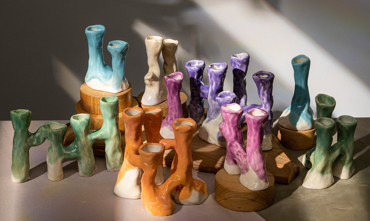Group of sculptural ceramic candle holders in teal, orange, lilac and cream glazes
