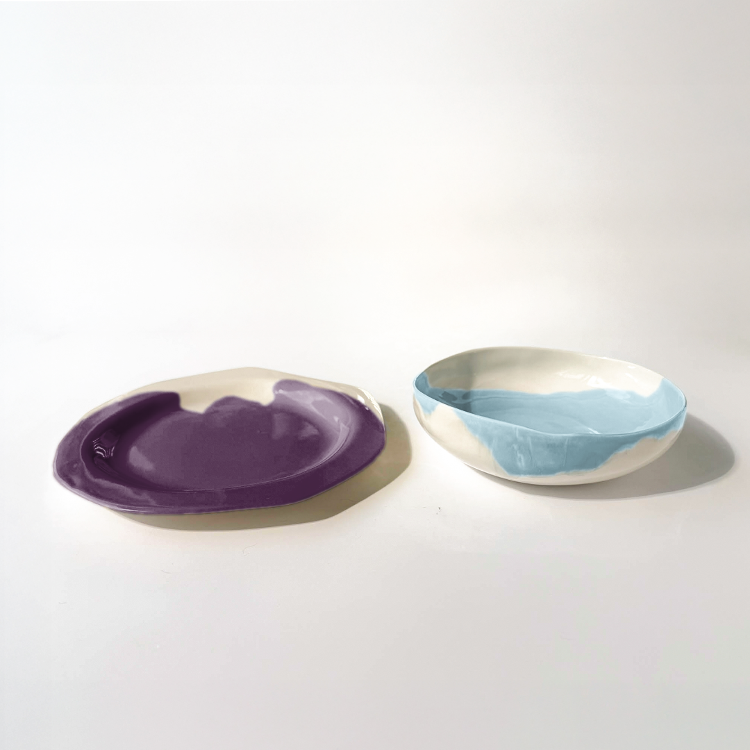 Purple-and-ivory ceramic plate beside a small sky-blue bowl