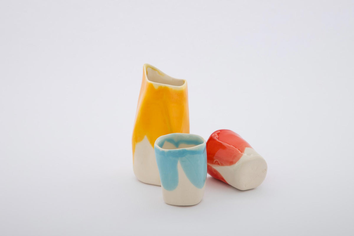 Bauhaus Coffee Set of porcelain milk jug in yellow and two cups in turquoise and red glaze
