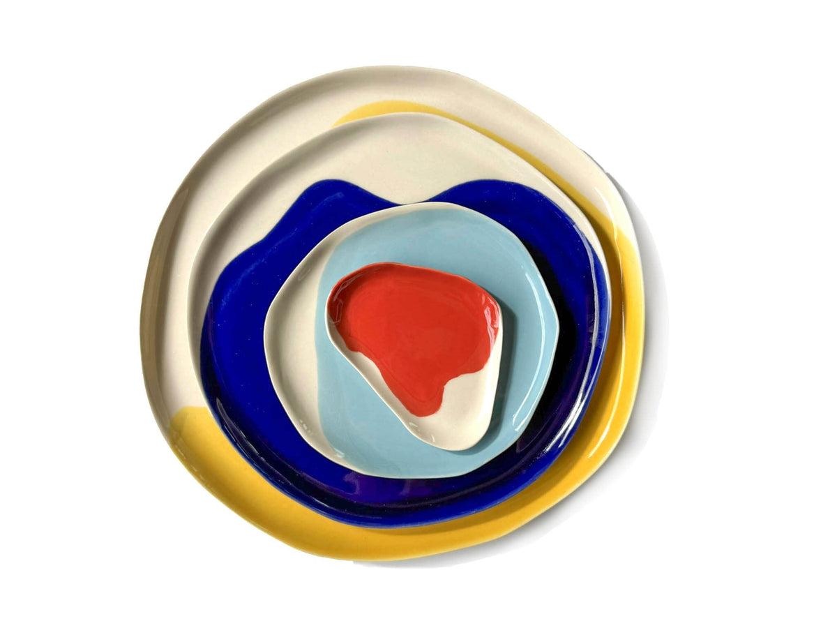 Bauhaus Plates Set 2 stacked in yellow, cobalt blue, mint and red glazes, viewed from above