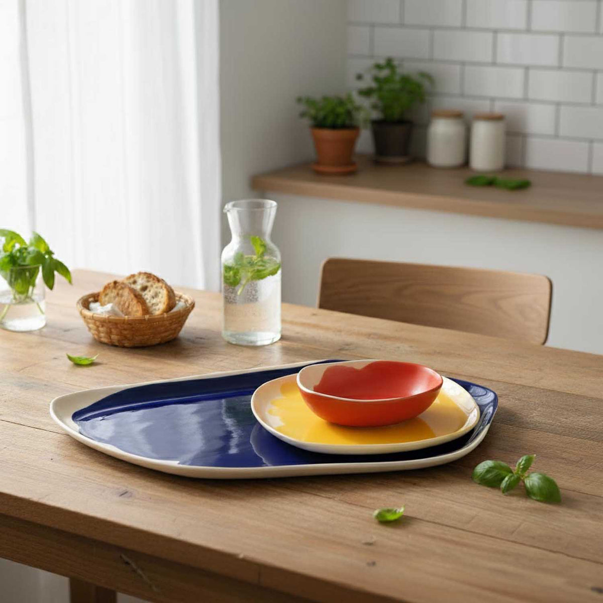 Bauhaus Porcelain Set of nested platter, plate and bowl in blue, yellow and red on a kitchen table