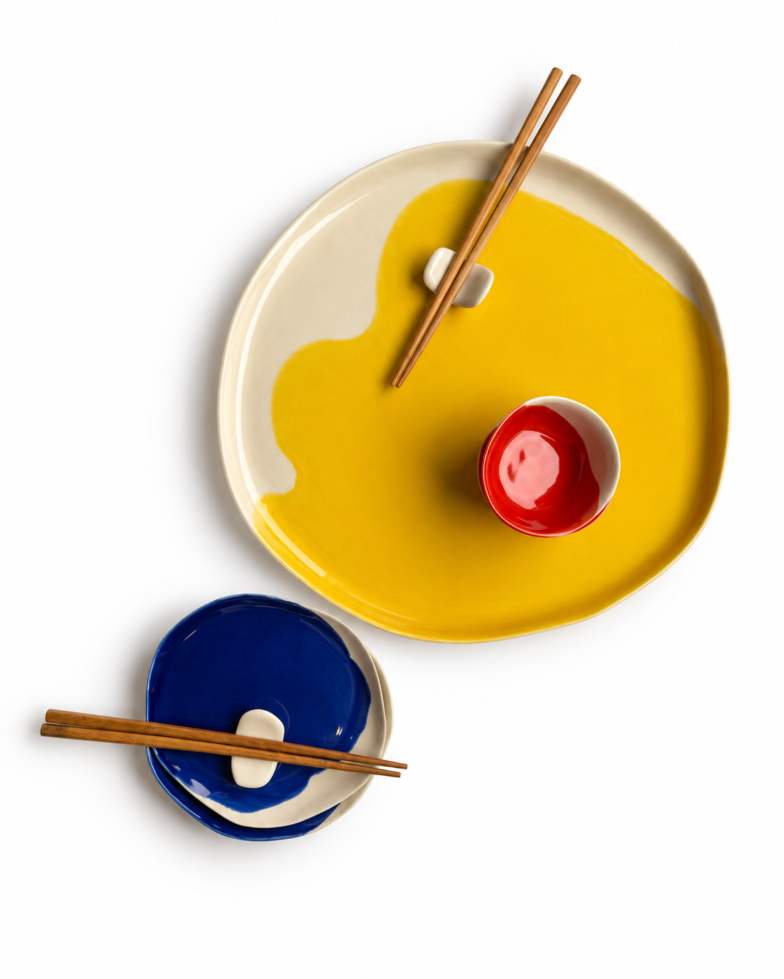 Bauhaus handmade ceramic sushi set for two with a 32 cm cadmium yellow serving plate, 16 cm ultramarine plates, scarlet red dip bowls and ceramic chopstick rests – view 1