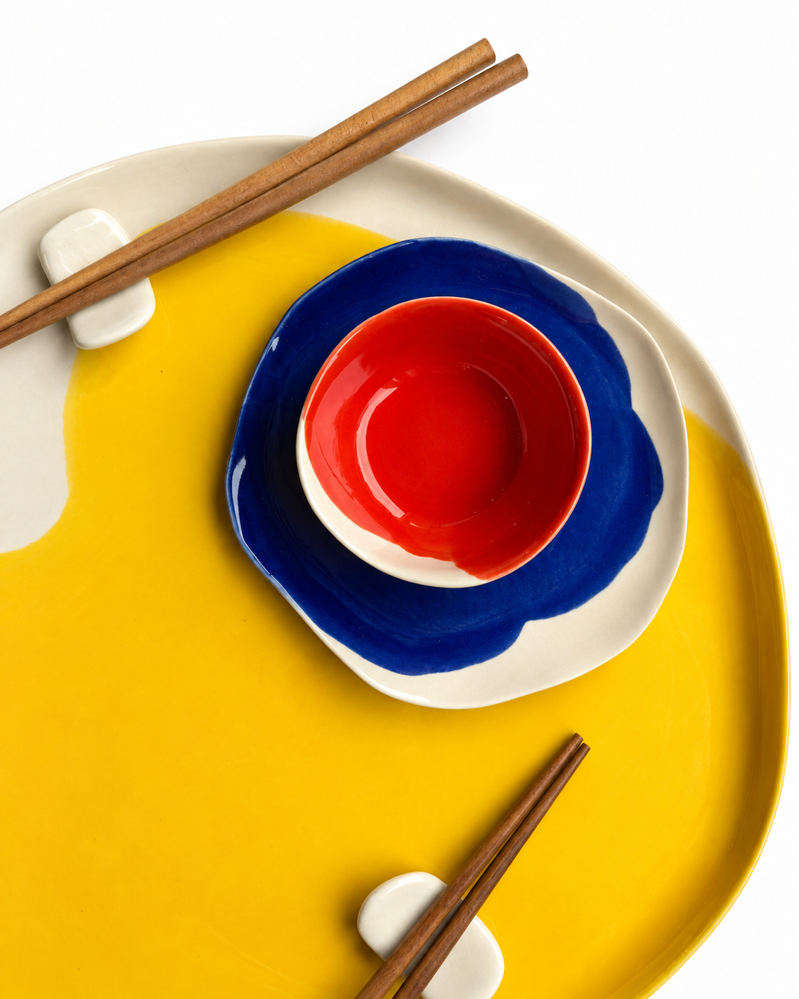 Bauhaus handmade ceramic sushi set for two with a 32 cm cadmium yellow serving plate, 16 cm ultramarine plates, scarlet red dip bowls and ceramic chopstick rests – view 4