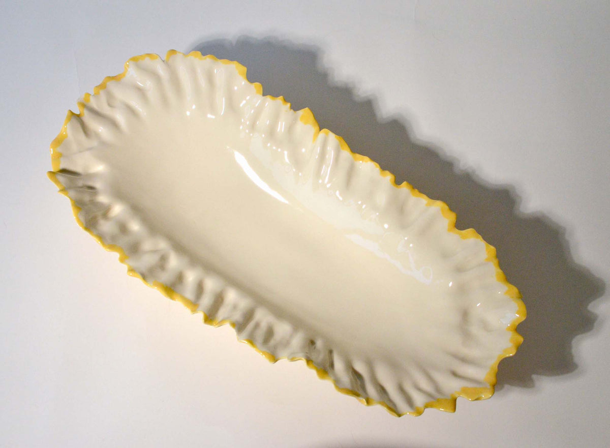 Blossom elevated serving bowl from above, white interior with a yellow petal-like rim