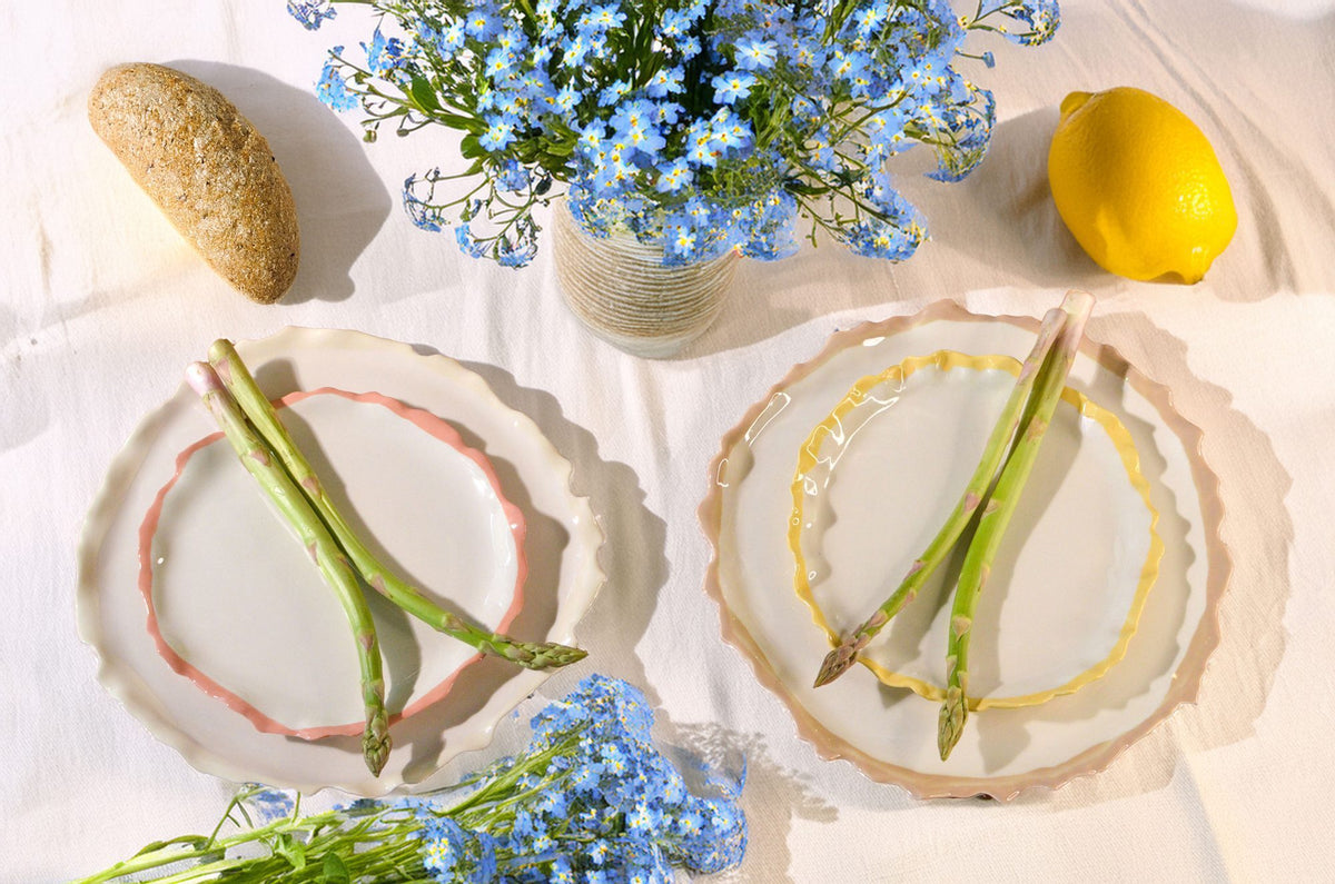 Blossom collection porcelain plates with wavy rims served with asparagus beside blue forget-me-nots