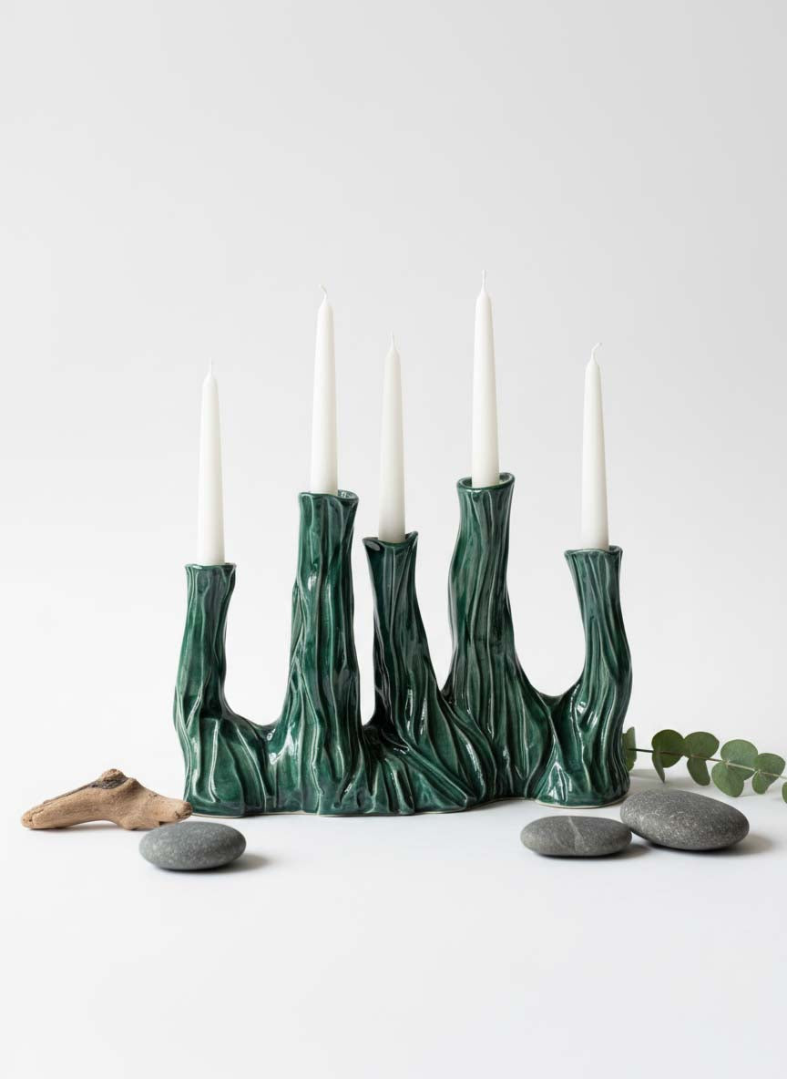 Blossom collection ceramic candle holder in textured dark green glaze holding five white candles