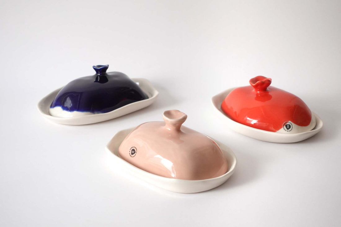 Three handmade porcelain butter dishes with cobalt blue, pale pink and coral red lids