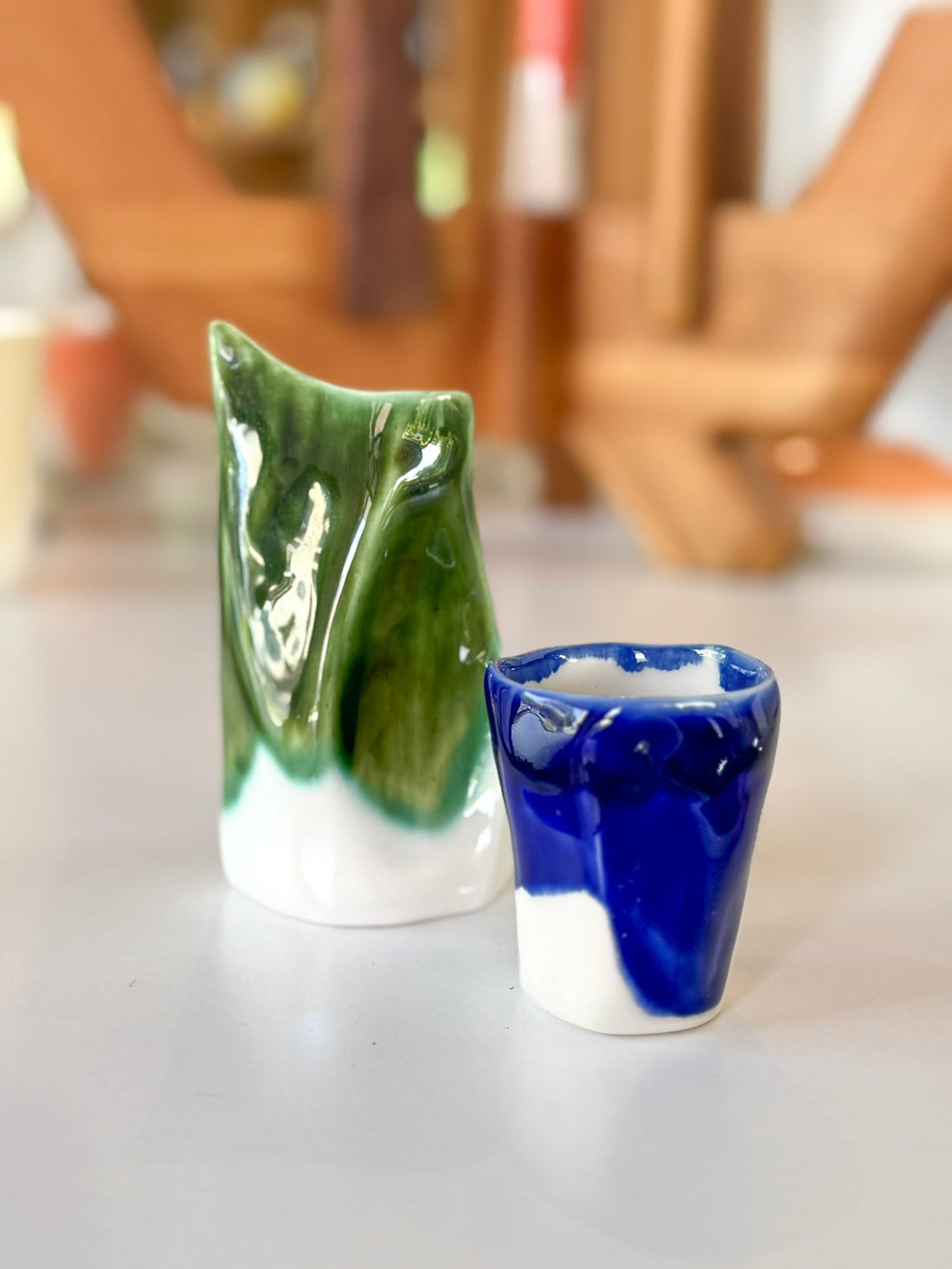 Handmade porcelain creamer in green and a cobalt blue coffee cup
