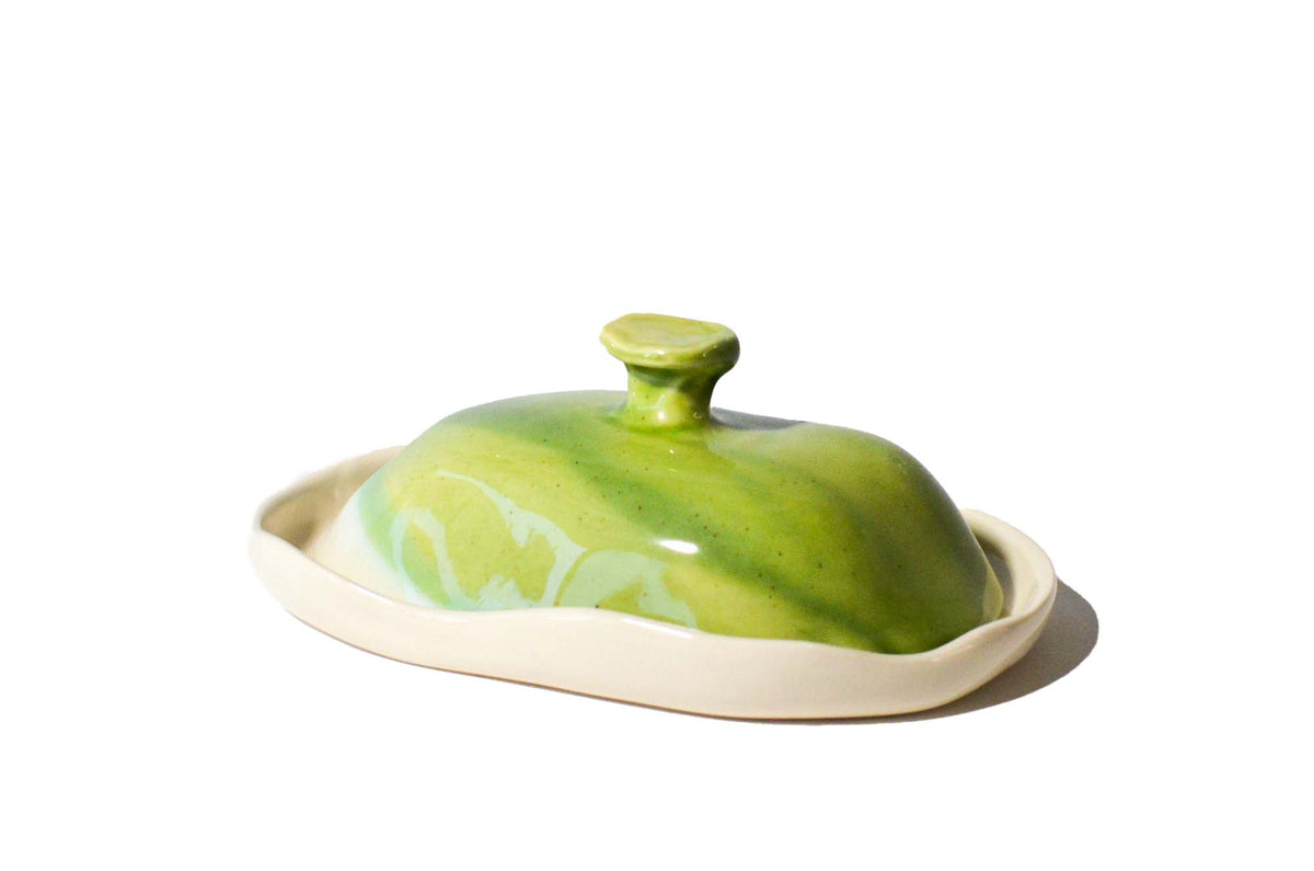Handmade porcelain butter dish with a sculptural Kiwi Green lid and ivory white base