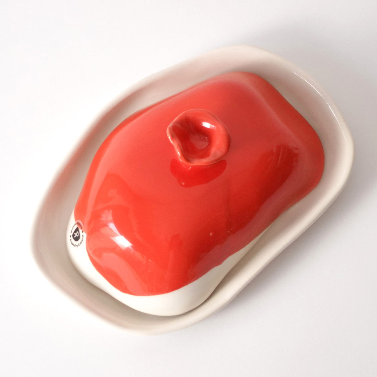Handmade porcelain butter dish in Red Scarlet glaze with an organic knob and white tray