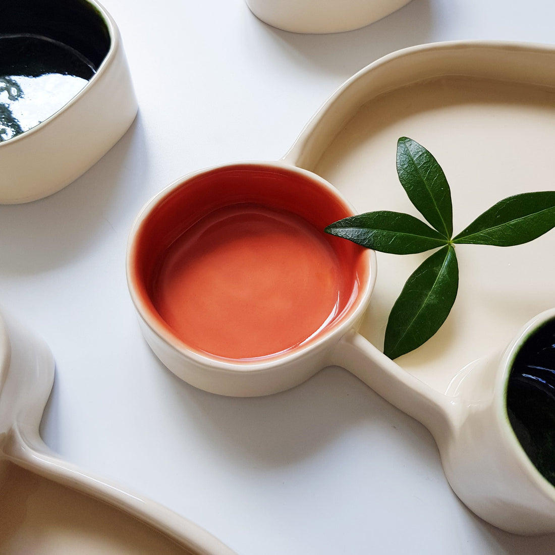 Ferrari Red glazed porcelain dip bowl set in a white multi-section serving tray with green leaves