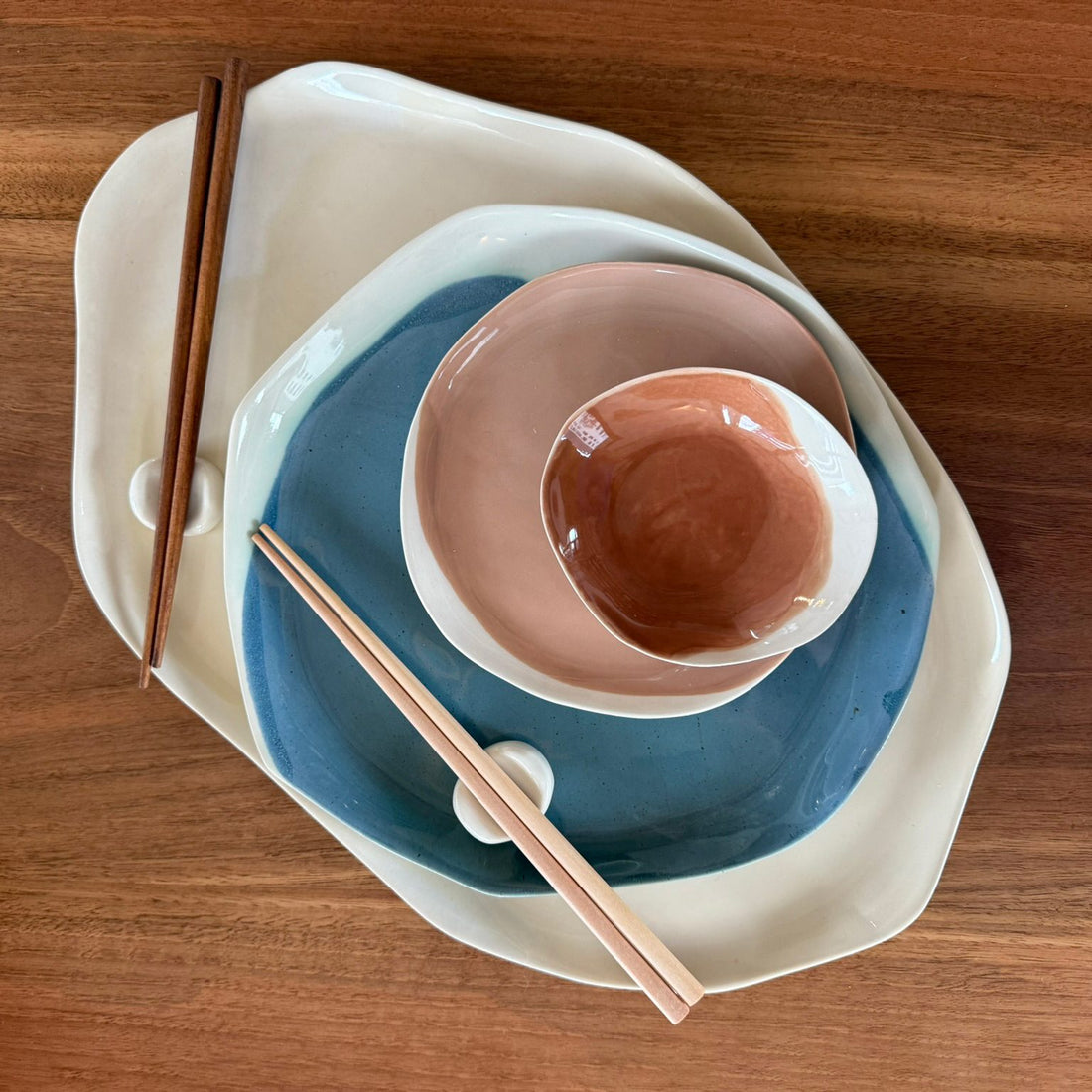 Layered handmade porcelain plates and bowls in Mocha Mousse and blue glaze with wooden chopsticks