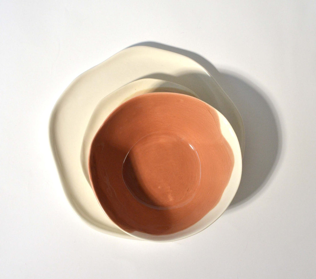 Porcelain bowl with a Hazelnut glaze interior set on a white plate, seen from above