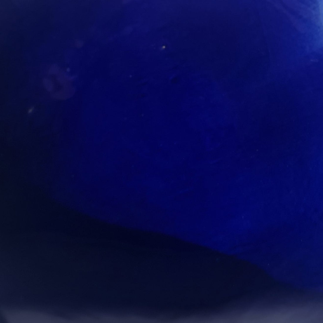 Close-up of glossy Royal Blue glaze sample on handmade porcelain