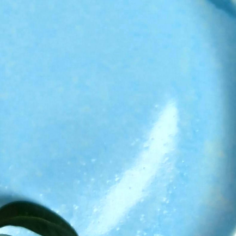 Close-up of glossy Sky Blue glaze sample on handmade porcelain