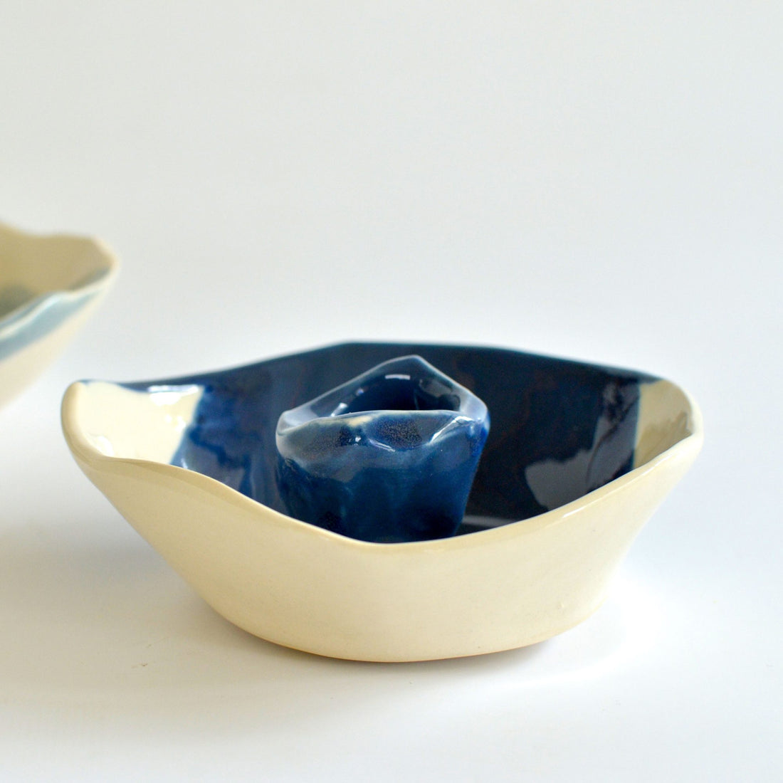 Organic handmade porcelain bowl with Dark Denim glaze inside and a raw cream exterior