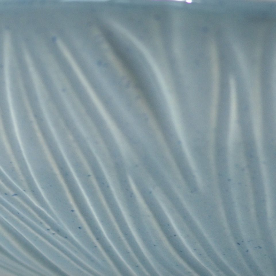 Light Denim glaze sample on textured handmade porcelain with fine wavy ridges