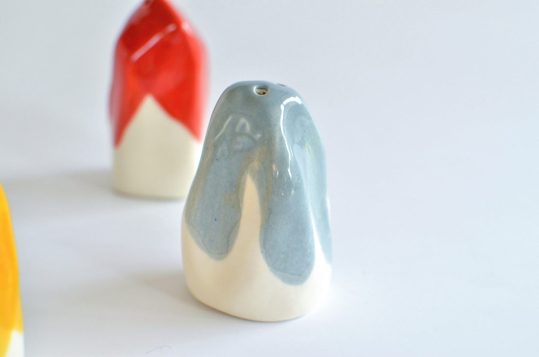 Porcelain salt and pepper shakers dipped in Light Denim and red glaze on white