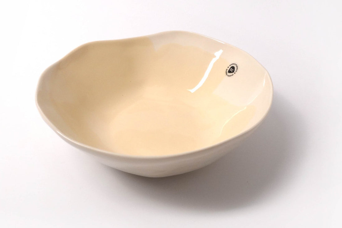 Handmade porcelain bowl in Ivory glaze with a soft, uneven organic rim