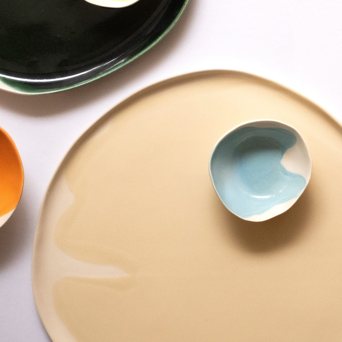 Large Ivory glazed porcelain platter with a small light blue ceramic dish from above