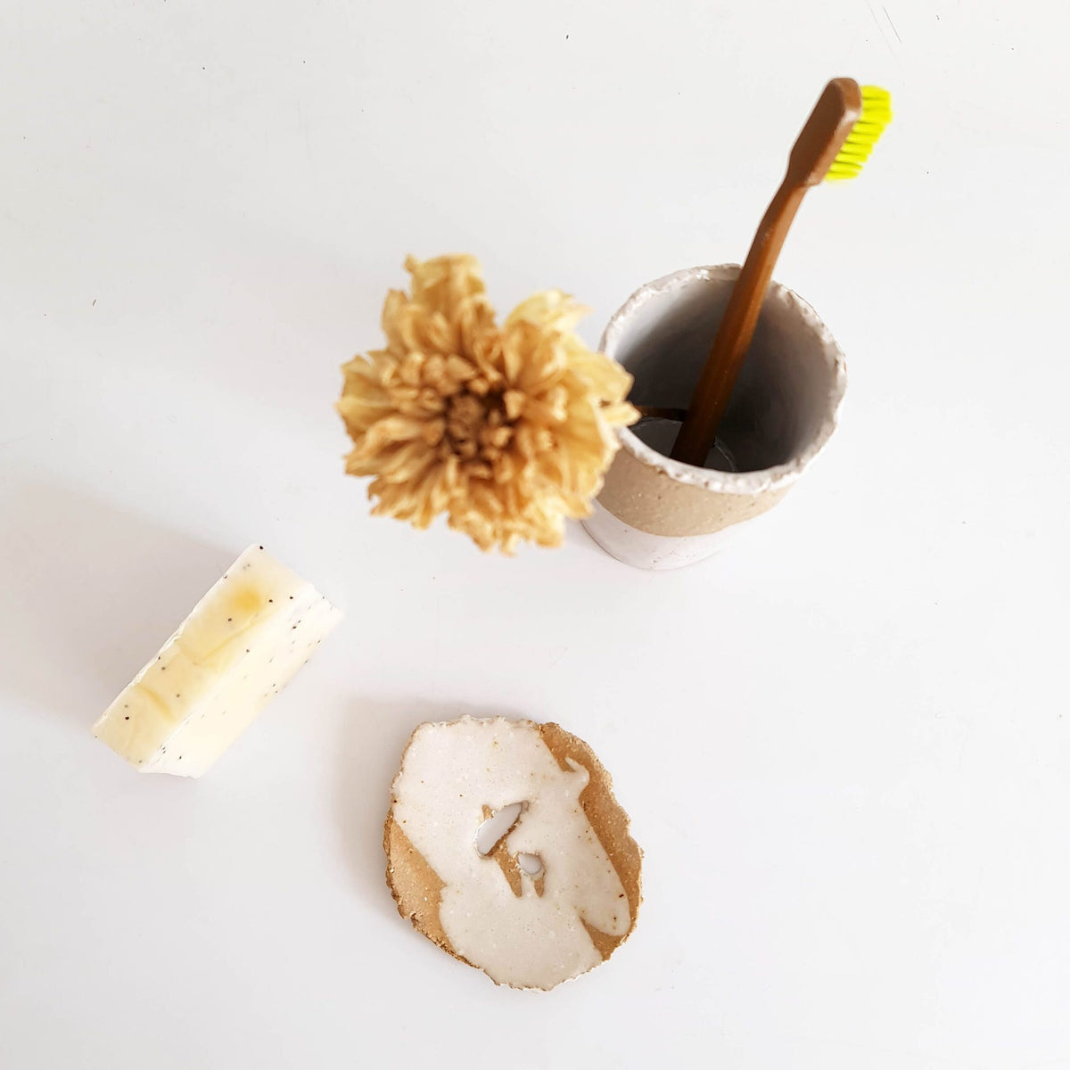 Handmade ceramic toothbrush cup and soap dish with a natural sponge, a sustainable gift idea