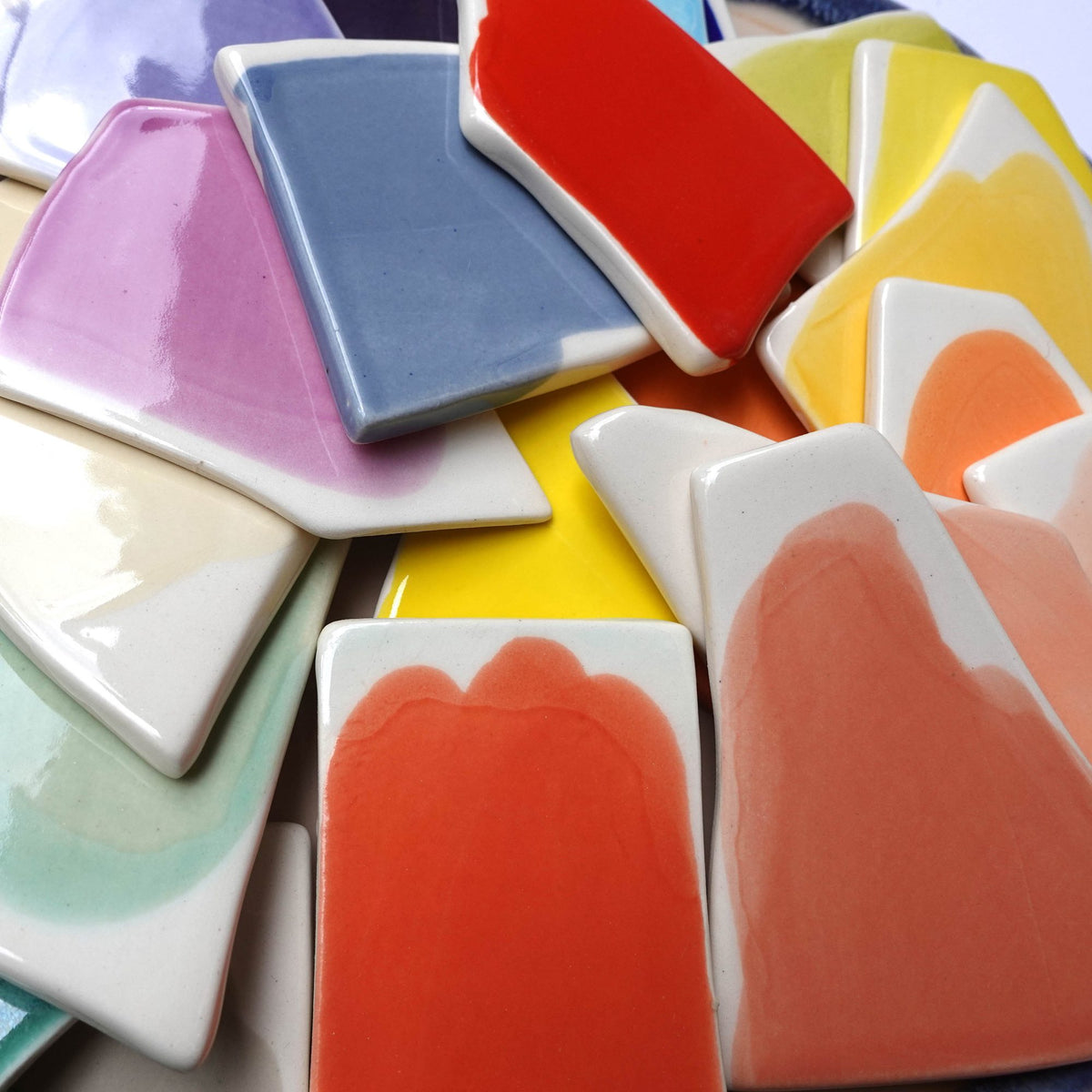 Glaze test tiles on handmade porcelain in lilac, blue, red, yellow and coral from our Sofia studio