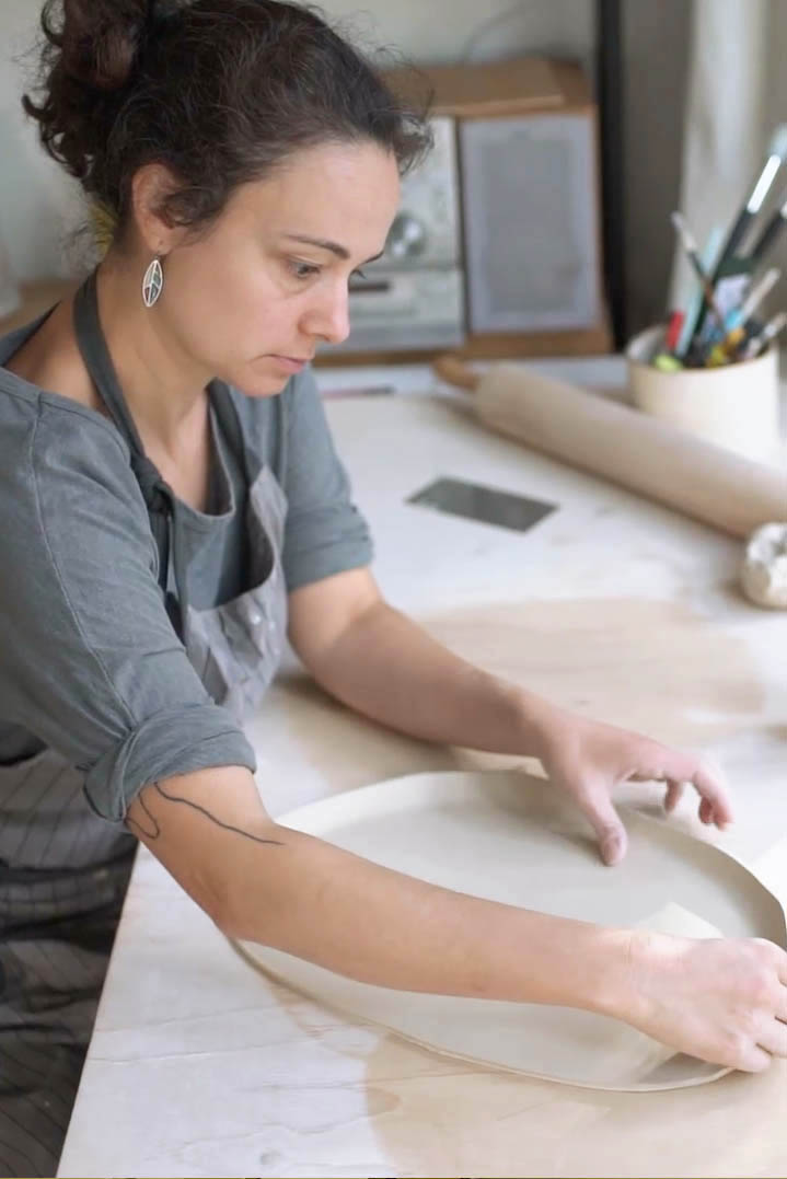 Ceramicist shaping a porcelain tray by hand at the in-house production table in our Sofia studio
