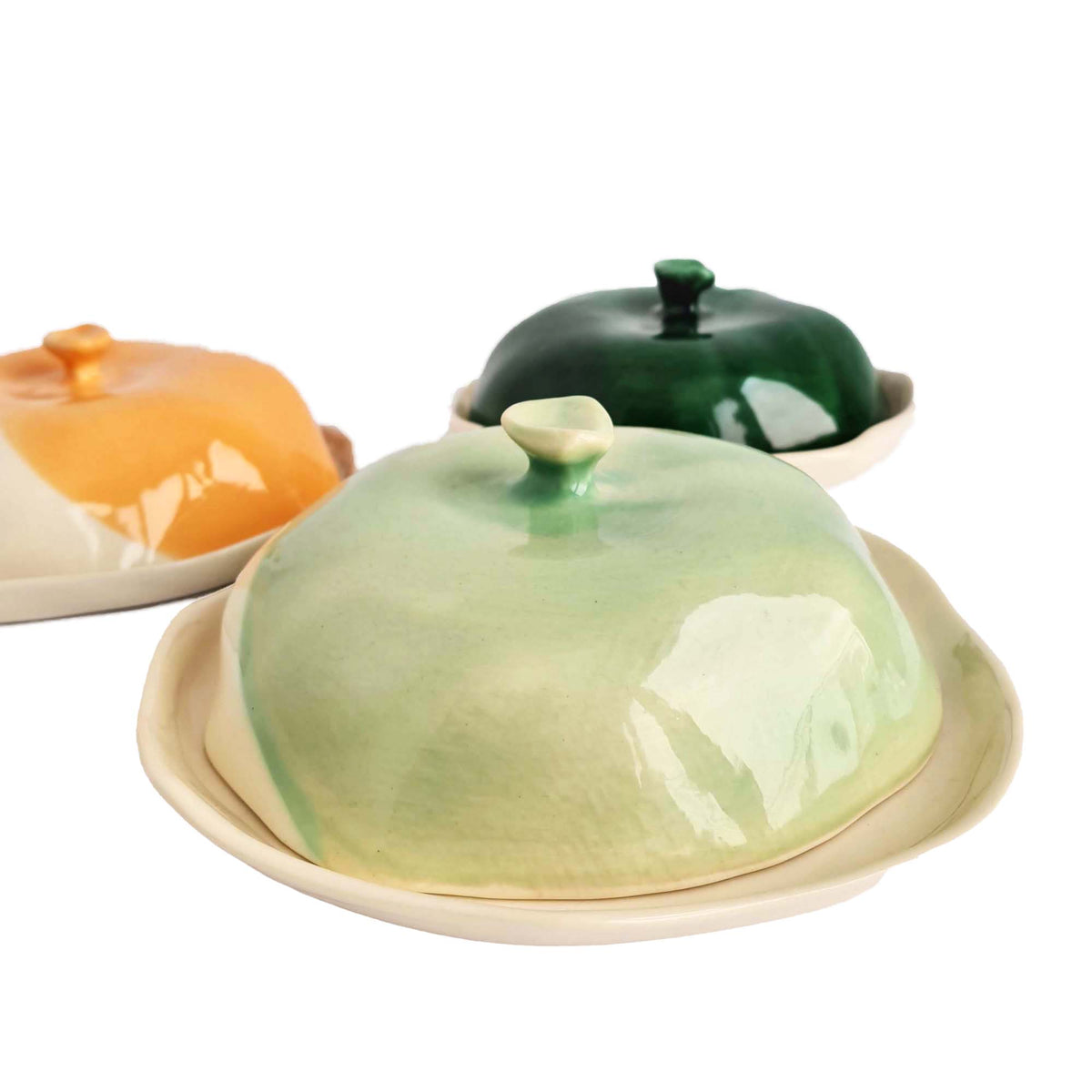 Handmade ceramic cheese boxes with domed lids in sage, dark green and orange glazes