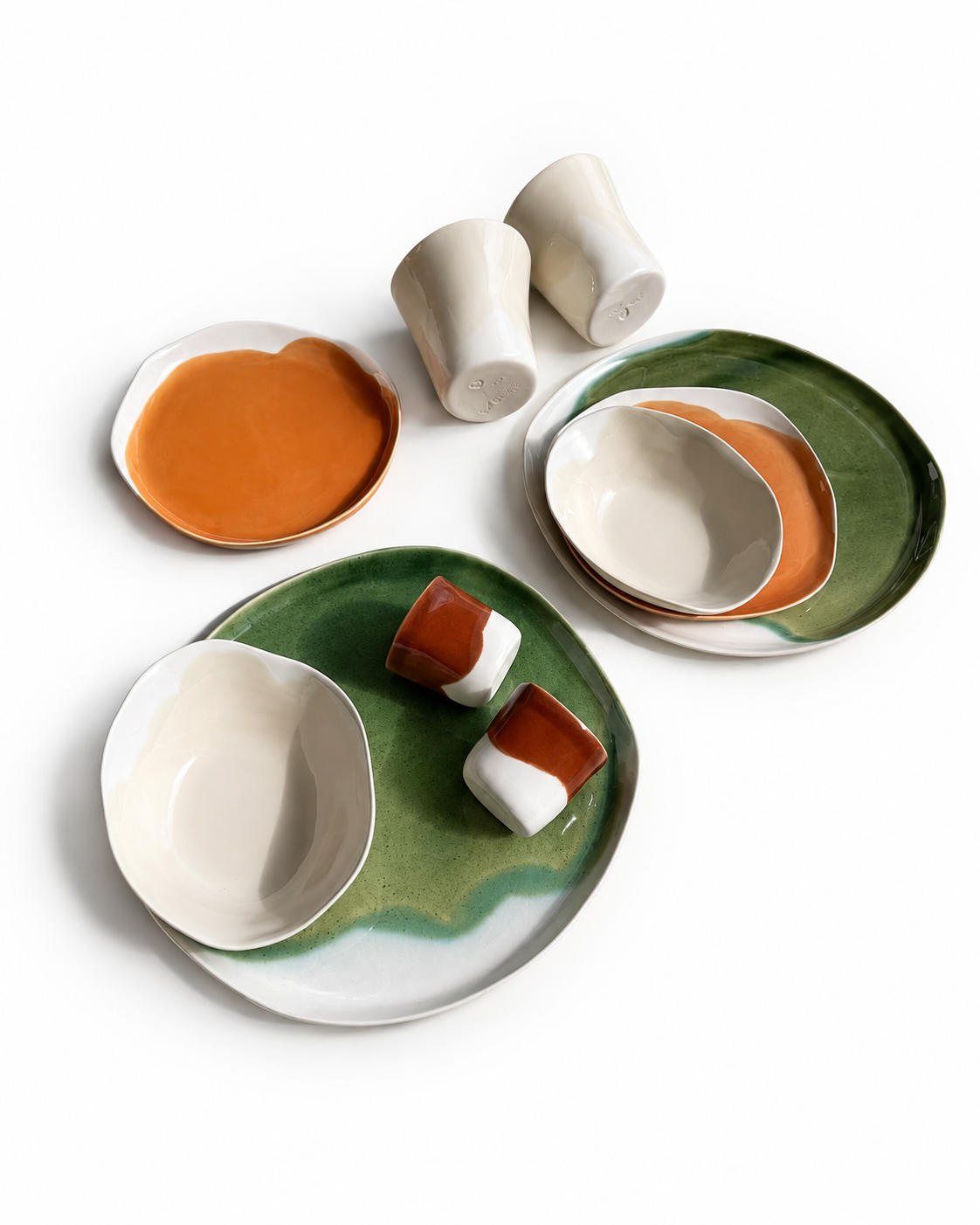 Ten-piece ceramic dinner set with orange plates, green dinner plates and ivory bowls