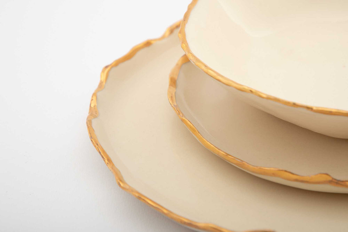 Detail of the irregular gold-finished rims on a Gilded Ridges dining set