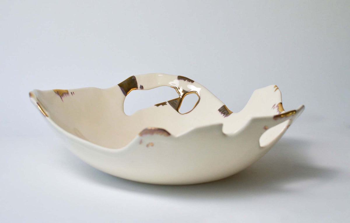 Wide ivory porcelain serving bowl from the Laced collection with openwork gold-edged rim