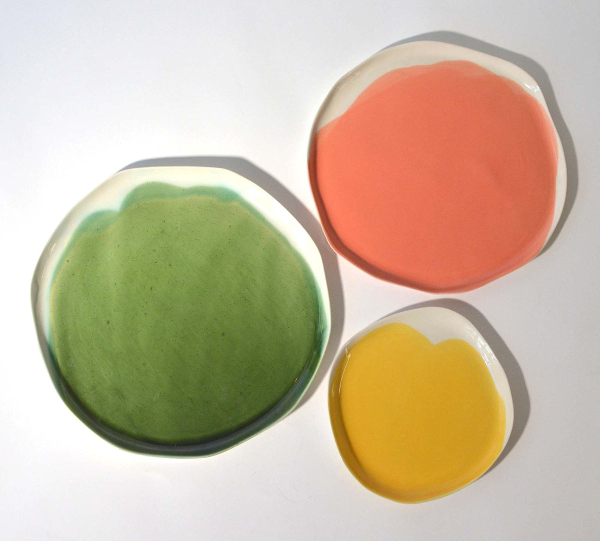 Green, coral and yellow handmade plates with irregular ivory edges
