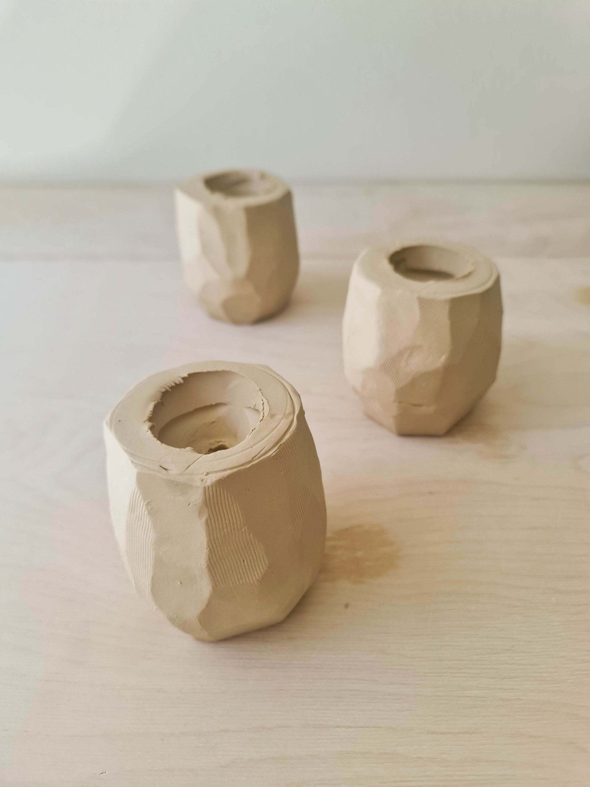 Carved kurinuki cups in raw clay before firing