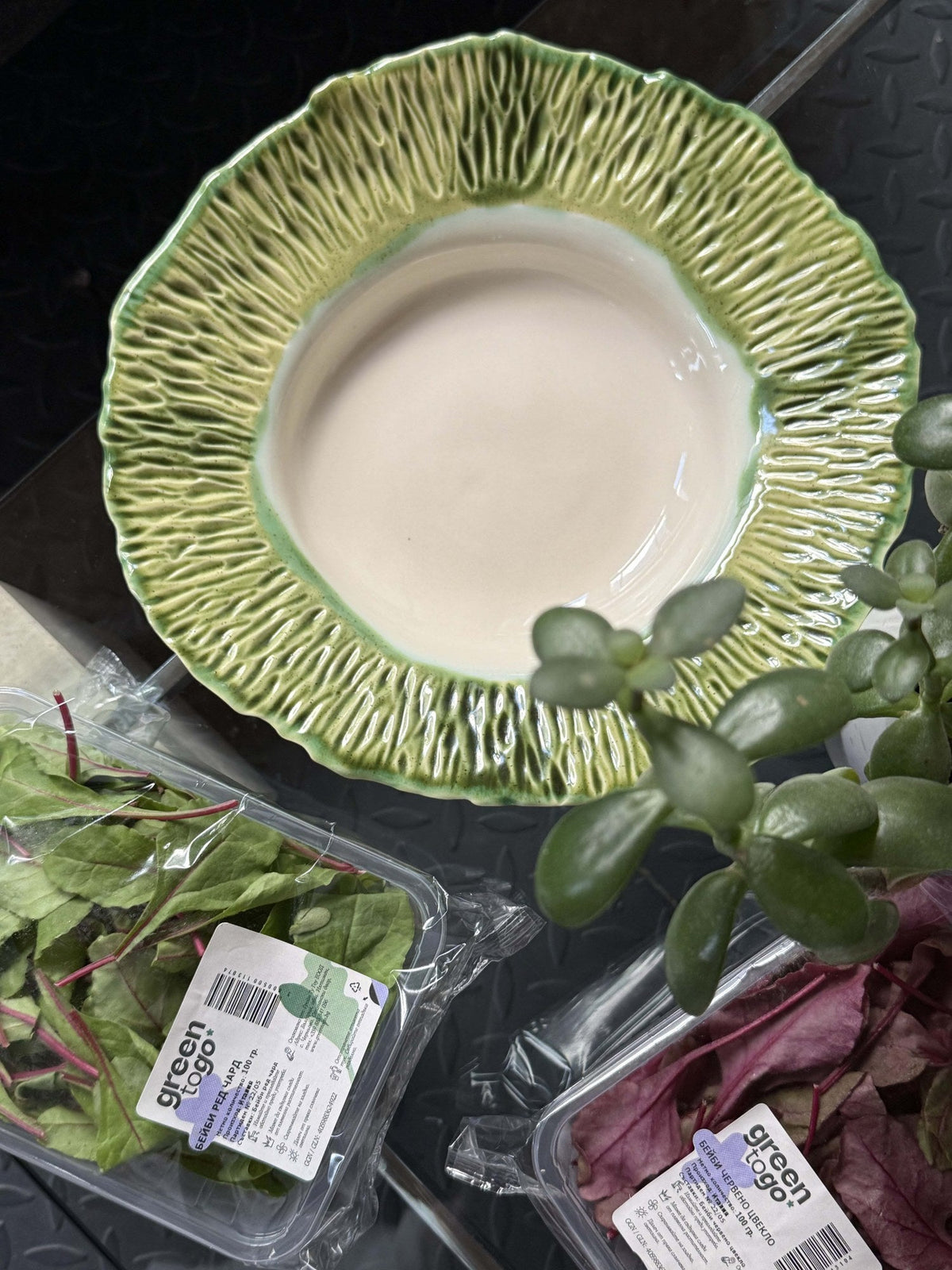 Green textured rim of the handmade porcelain plate from above