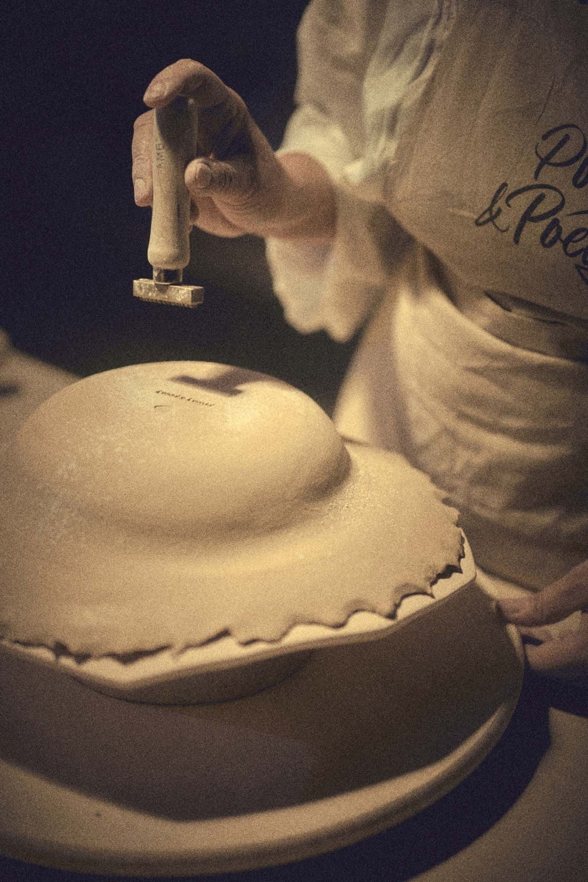 Stamping the Pottery & Poetry mark under the deep plate by hand