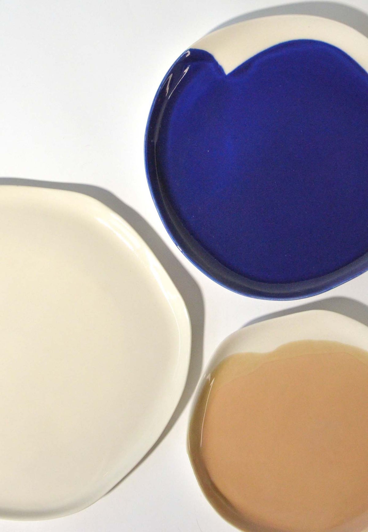 Royal-blue, ivory and beige handmade plates viewed from above