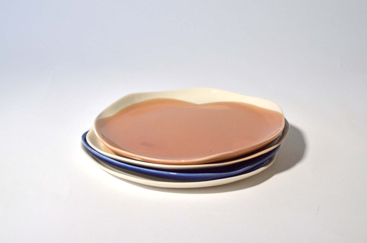Stack of pink, ivory and dark blue handmade dinner plates