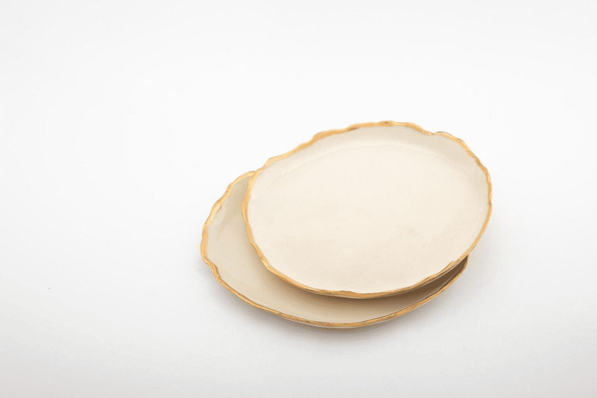 Two ivory Gilded Ridges ceramic side plates with handmade gold-edged rims