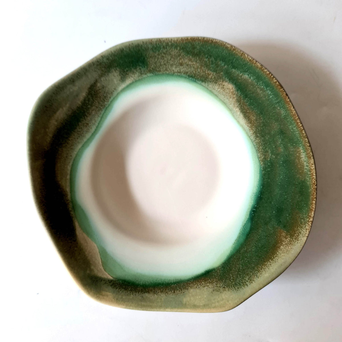 Chef's Table porcelain bowl with a white centre and dark green glaze flowing to the rim