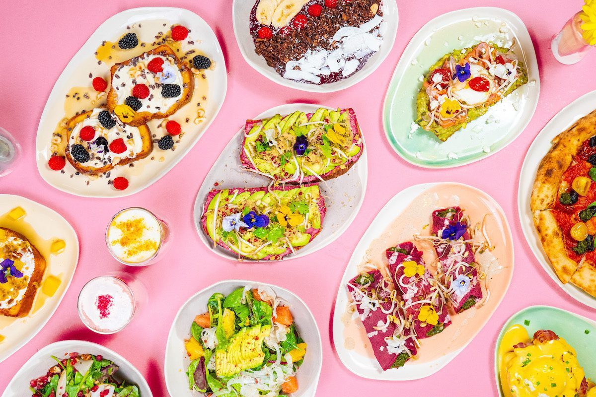 Colourful dishes served on handmade ceramic plates on a pink table