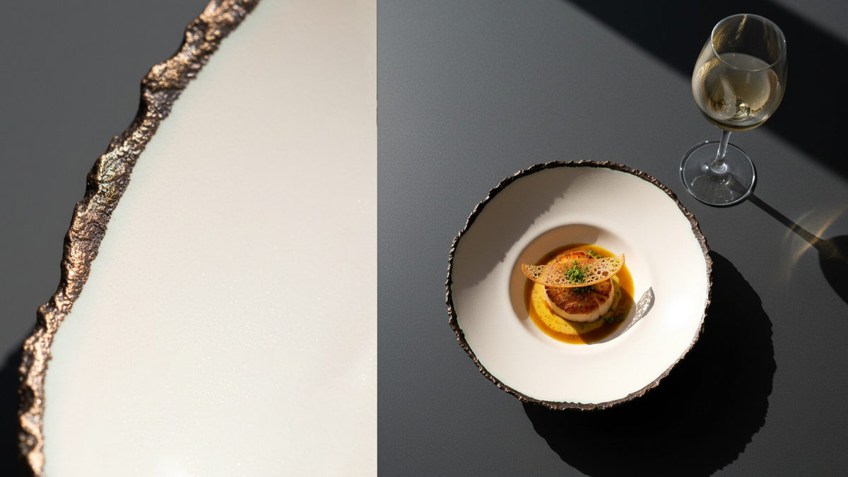 Fine-dining dish in an ivory ceramic bowl with a dark irregular rim