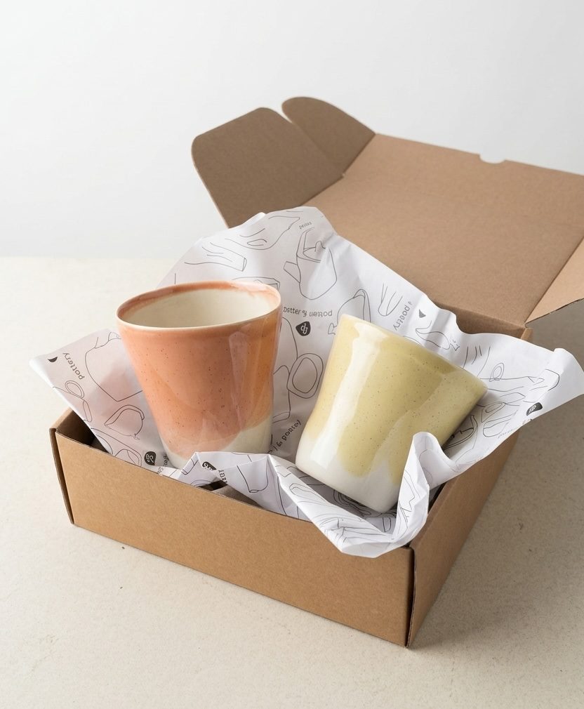 Set of 2 Large Cups in peach and pale yellow glaze in a kraft paper gift box